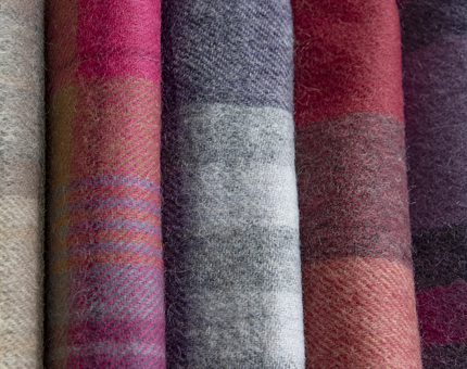 Multicoloured tartan scarves.