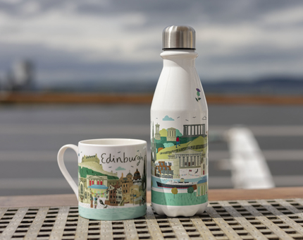 A mug and a water bottle with an illustrated image of Edinburgh on them.
